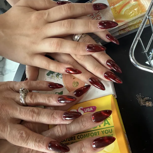 Rich crimson red long nails with dimensional shimmer